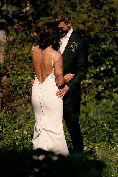 Bride and groom sharing an intimate moment outdoors.