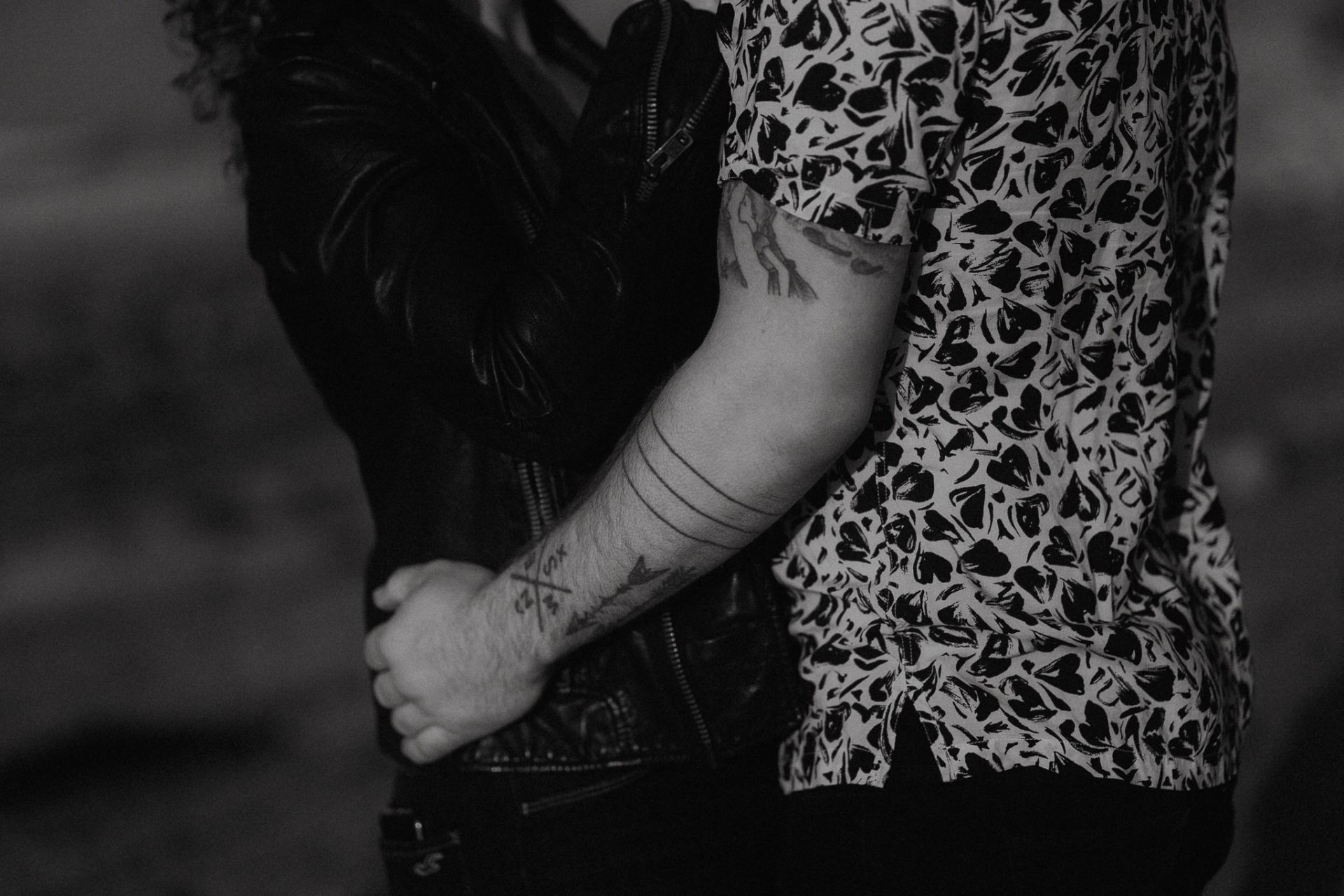 A black and white photo of a couple hugging in the dark.